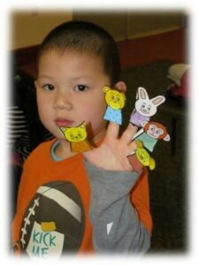 Child with Finger Puppets